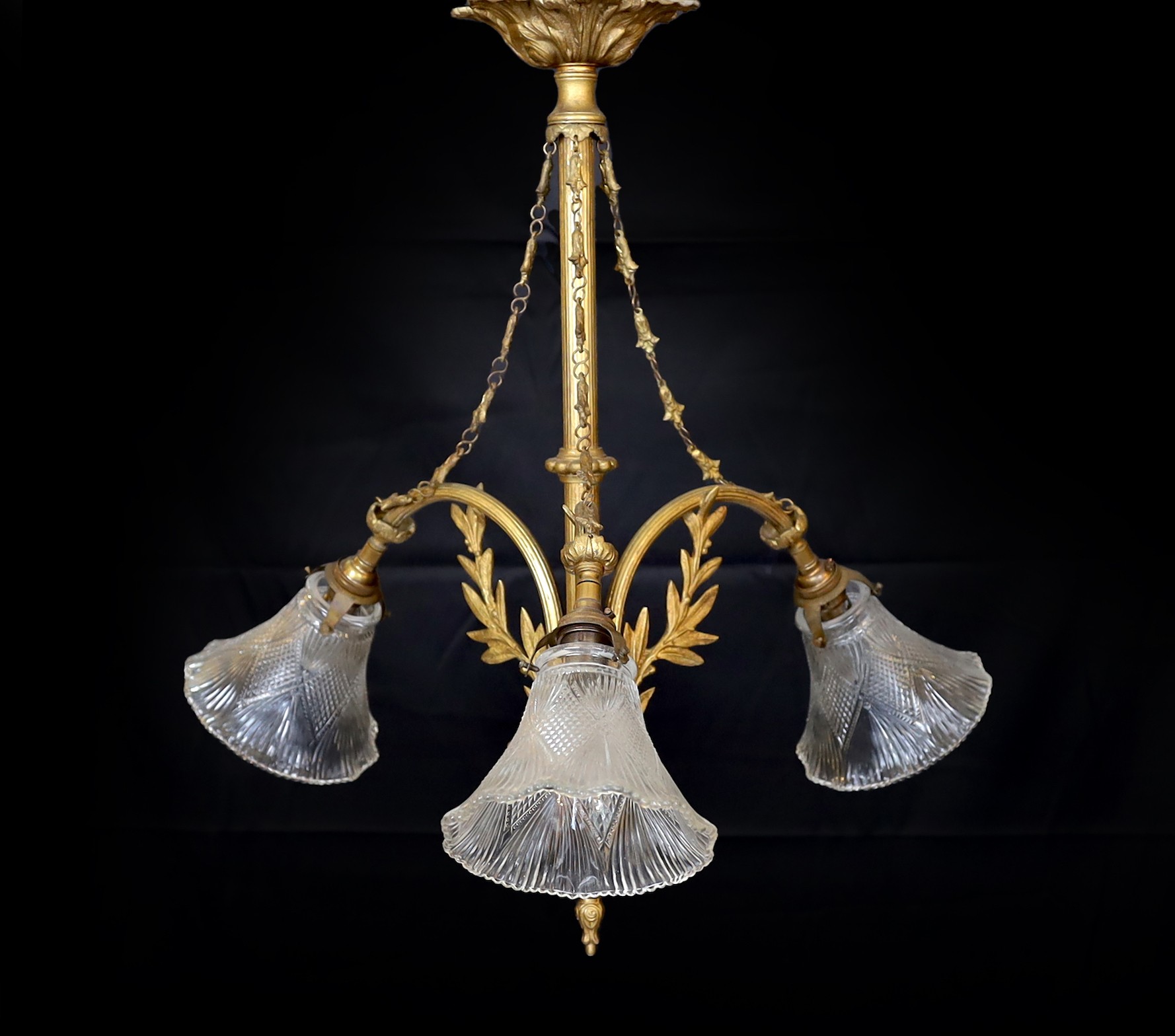 A 20th century French gilt brass three light chandelier with cut glass shades, height 60cm. width 60cm